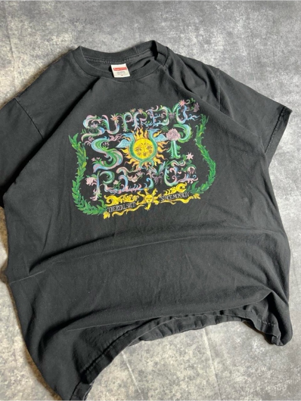 Supreme Black Tee with Vibrant Sun & Floral Graphic